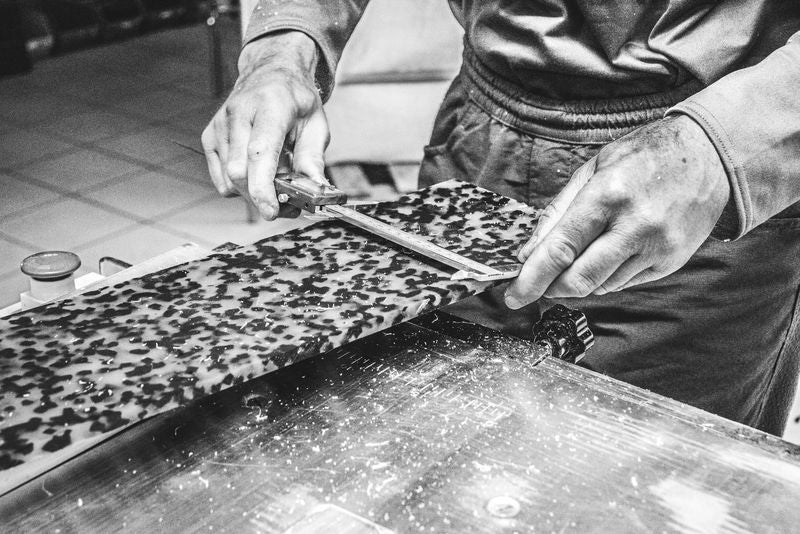 Craftsperson measuring patterned acetate for Cubo eyewear