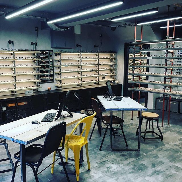 Inside Glasseslab Opticians, with illuminated frame displays and consultation tables.